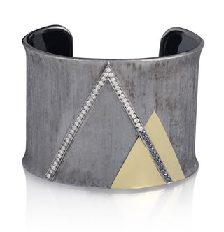 Wide silver bracelet with geometric design on a white background