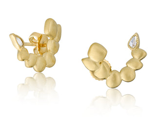 Close up view of 18kt yellow gold Seaside earrings featuring a unique half-sphere shape built out of our pebbled gold Seaside design by John Apel.