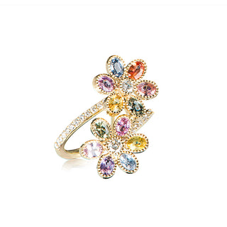 A multi-colored floral sapphire bypass ring with diamonds set in 18kt yellow gold.