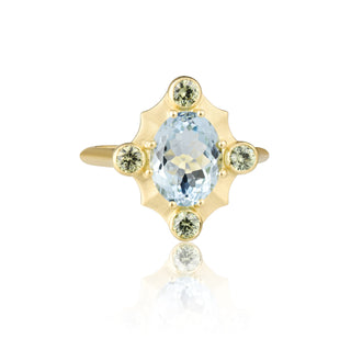 Gold ring with a aqua center stone and smaller green stones by John Apel